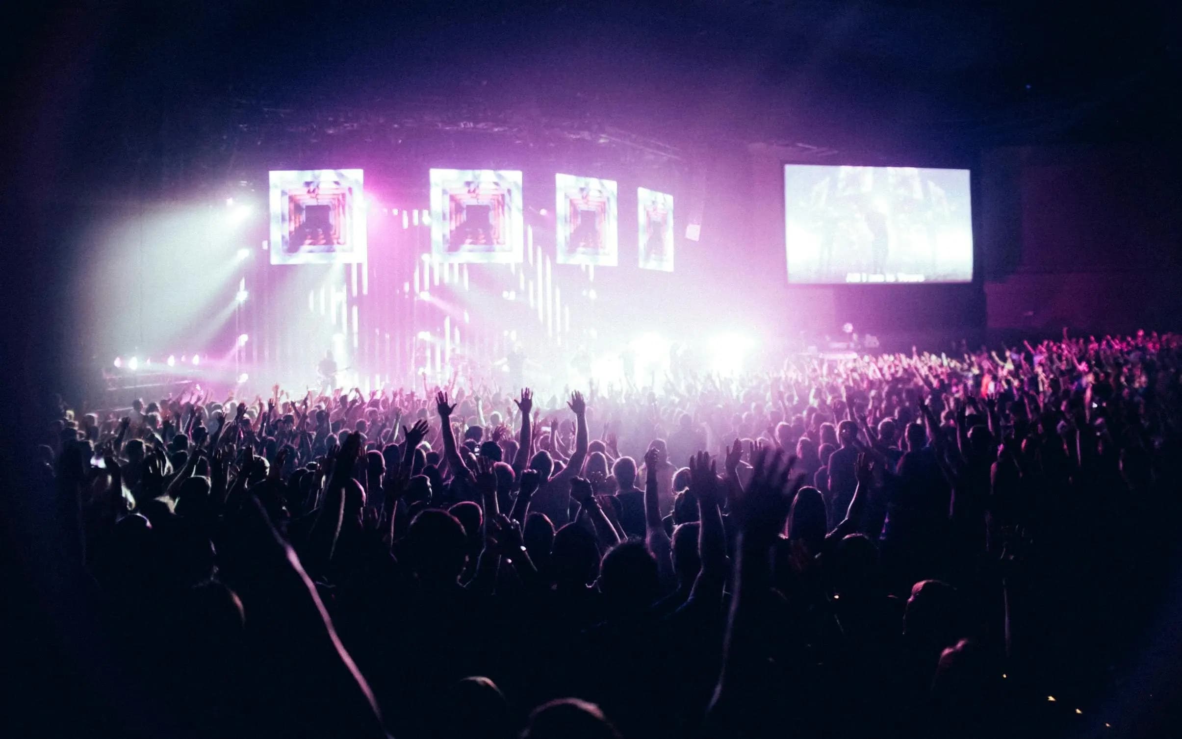 indoor people watching concert